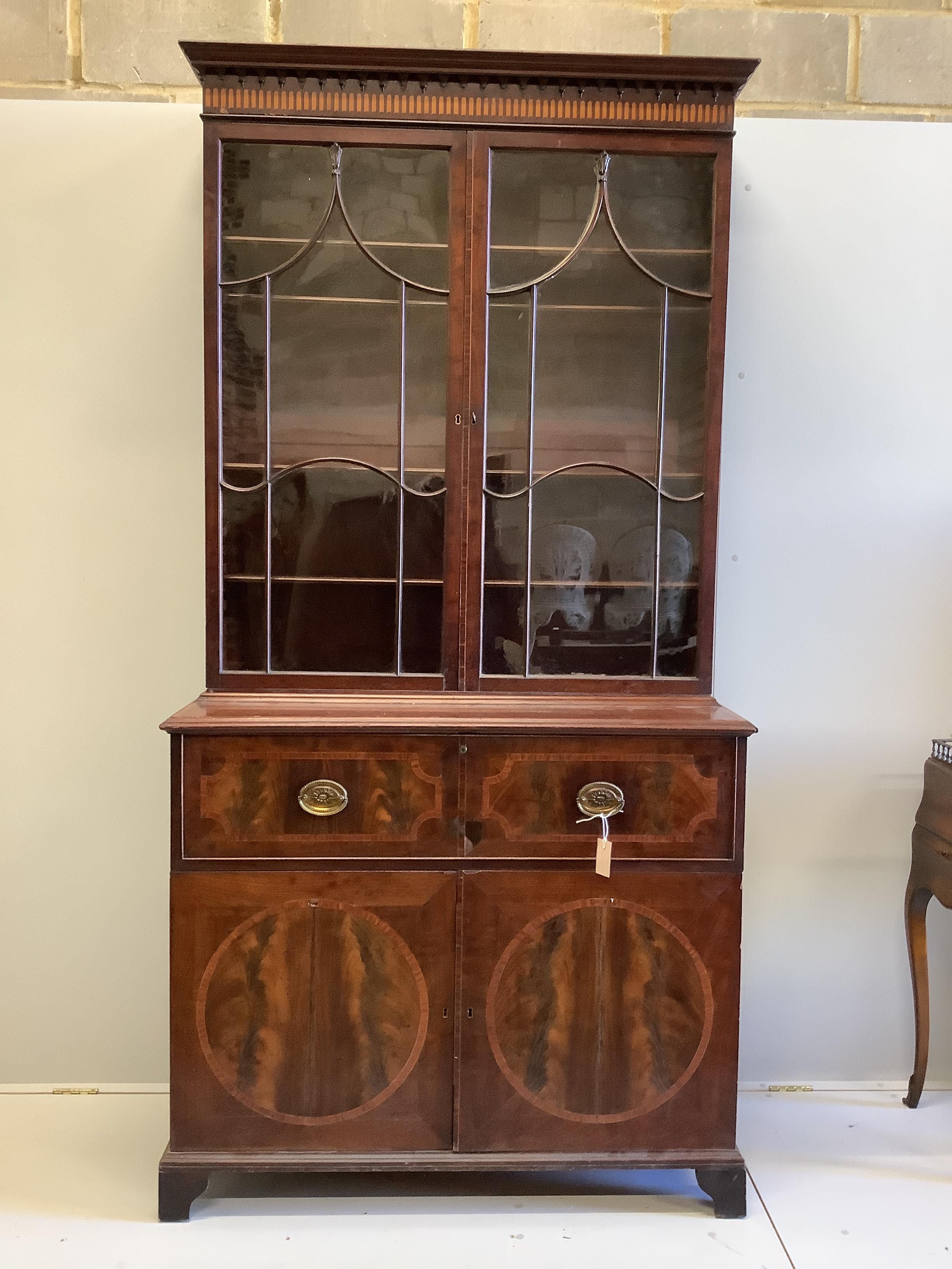 A George III satinwood banded mahogany secretaire bookcase, width 117cm, depth 58cm, height 236cm (a.f.)